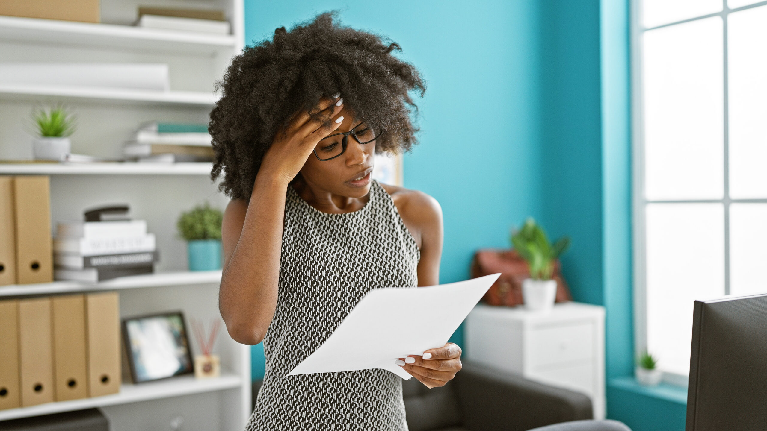 African american woman business worker reading document at the office